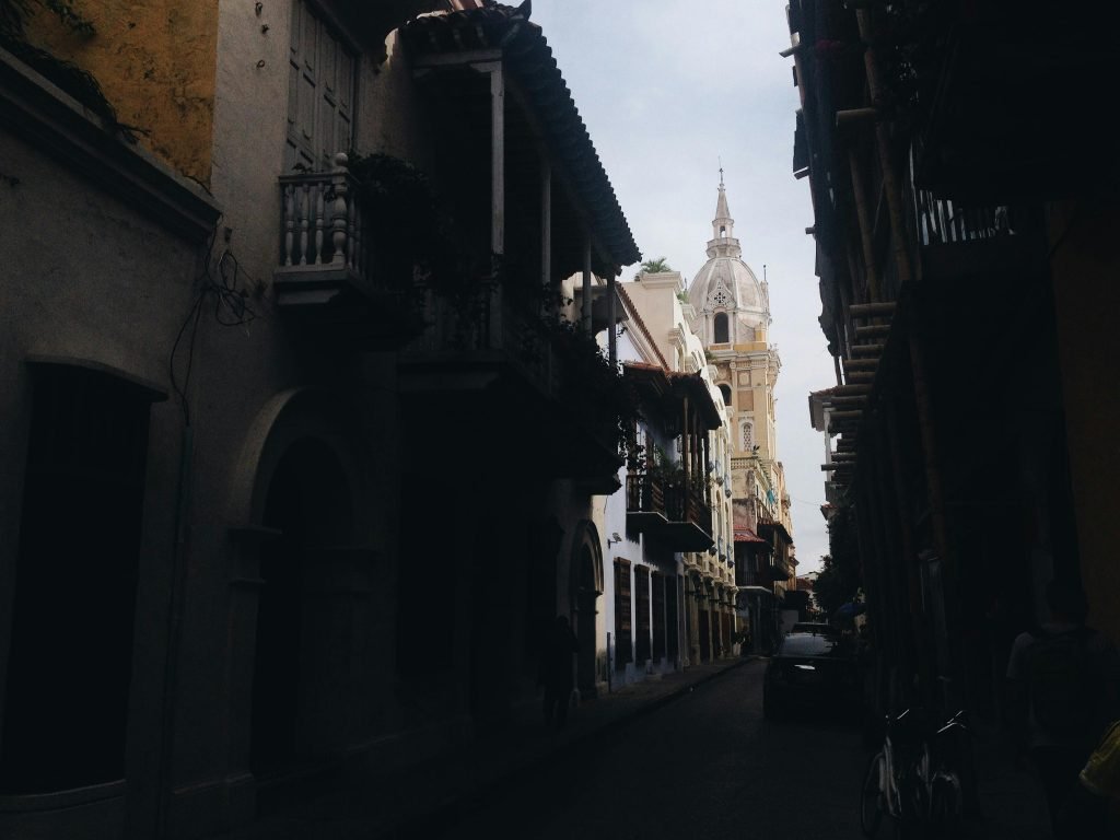 Moody urban street scene with historic tower, showcasing classic architecture, viajes a Cartagena