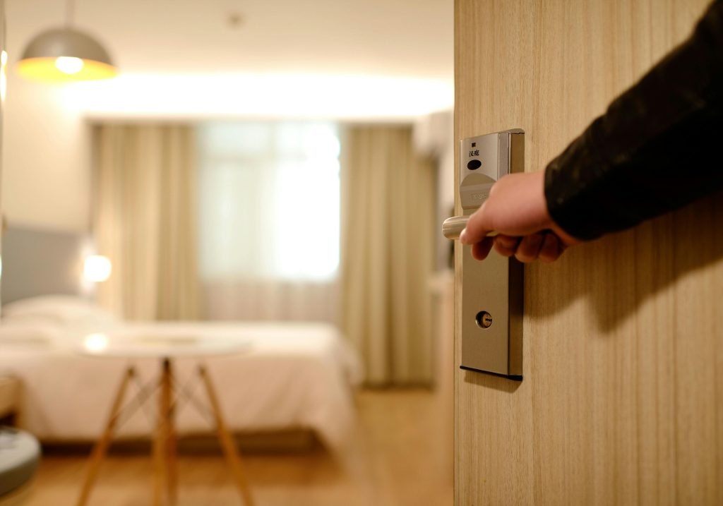 A soft-lit hotel room entrance, welcoming guests with luxury appeal and comfort, turismo en Medellín