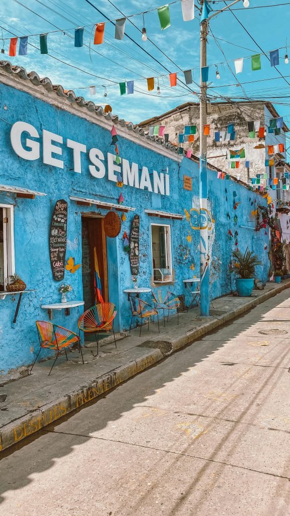 Vibrant blue facade in Getsemaní, Cartagena with colorful decorations and flags, Qué hacer en Cartagena
