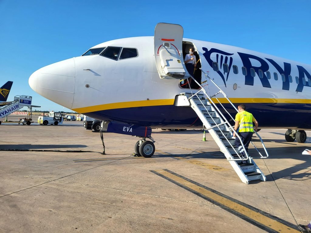 Traveler boarding a Ryanair aircraft at an airstrip in the Balearic Islands, Spain., pasajes