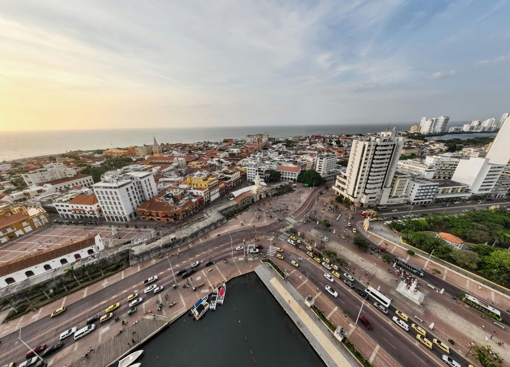 A breathtaking aerial view capturing Cartagena's vibrant streets, historic architecture, and stunning waterfront at sunset., paquetes a Cartagena todo incluido