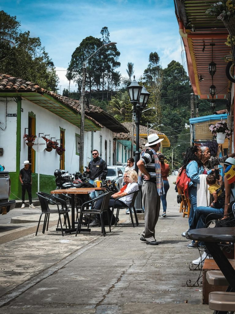 Experience vibrant street life in Salento, Colombia with colorful houses and lively locals., requisitos para viajar a Colombia