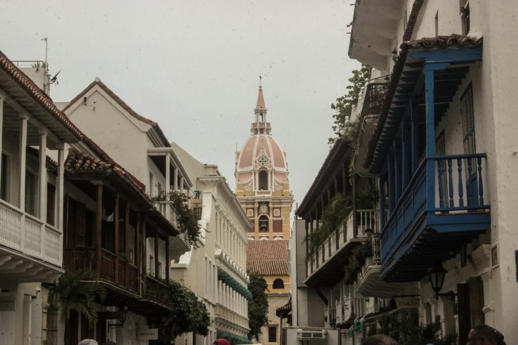 Charming colonial street view with historic cathedral tower in the background., paquetes a Cartagena todo incluido