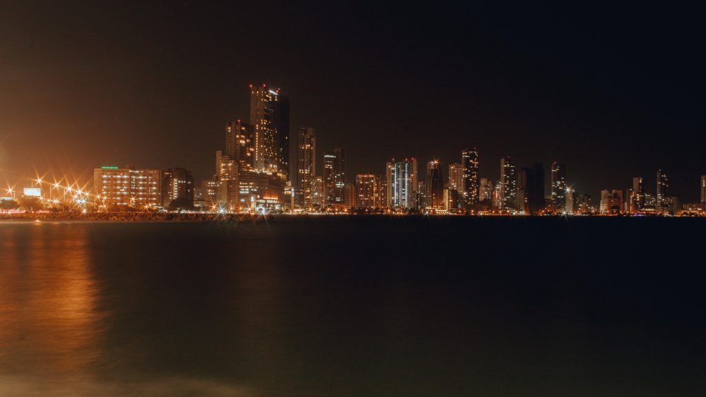 Stunning night view of Cartagena's illuminated skyline reflecting on the water., paquetes a Cartagena todo incluido