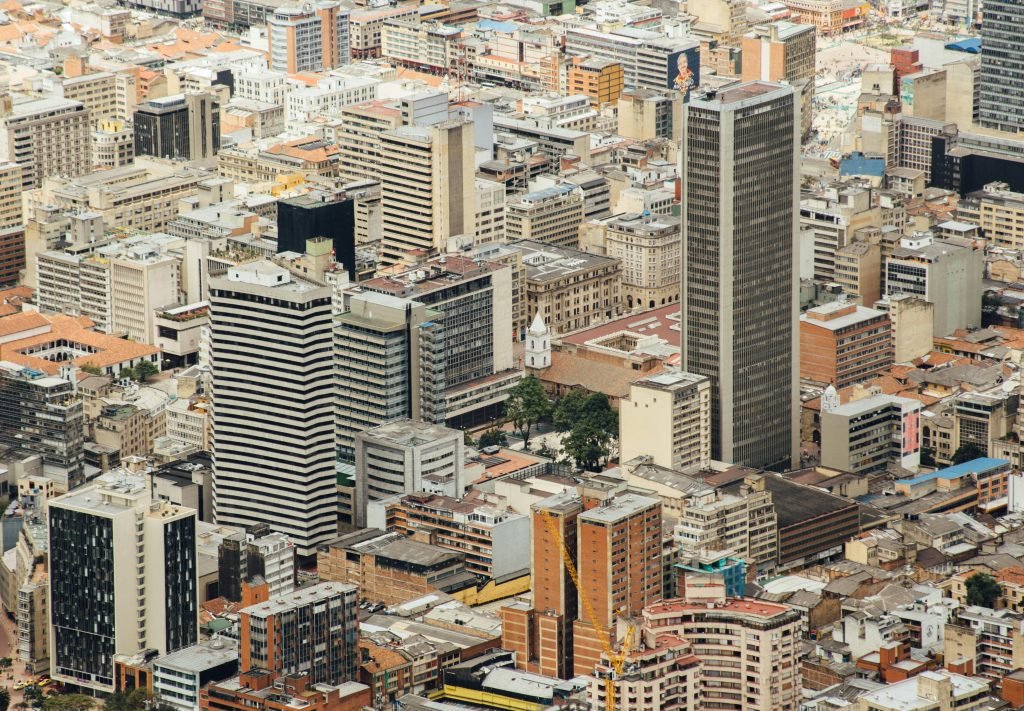 Aerial cityscape of downtown Bogotá featuring modern skyscrapers and urban architecture., ¿es seguro viajar a Colombia?