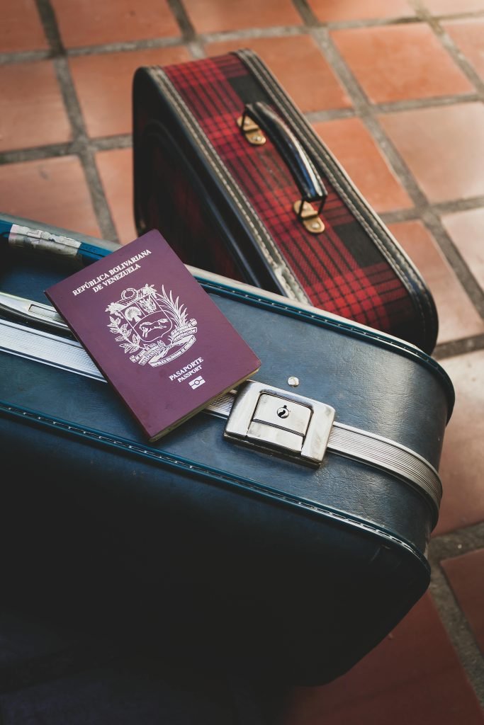 Venezuelan passport resting on vintage suitcases, ideal travel concept imagery for vacation and adventure themes., equipaje