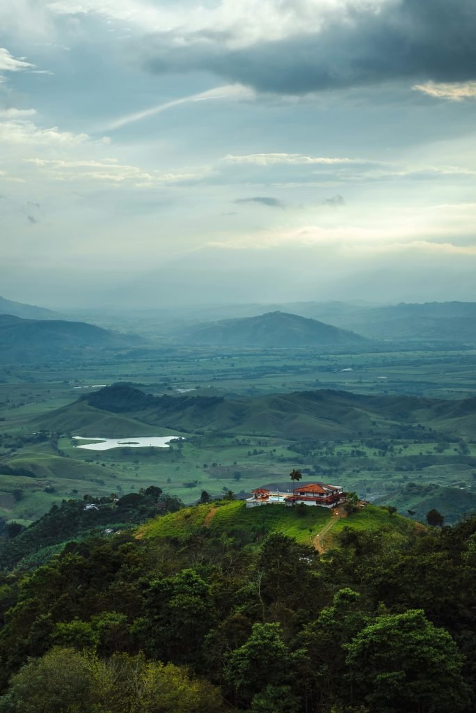 A picturesque aerial view of the rural landscape in Bugalagrande, Colombia, featuring hills and forest., requisitos para viajar a Colombia