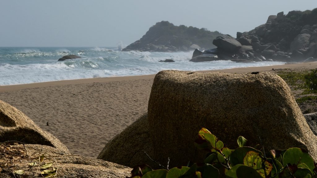 Panoramic view of Santa Marta beach with boulders and ocean waves. Perfect for nature lovers., Tayrona