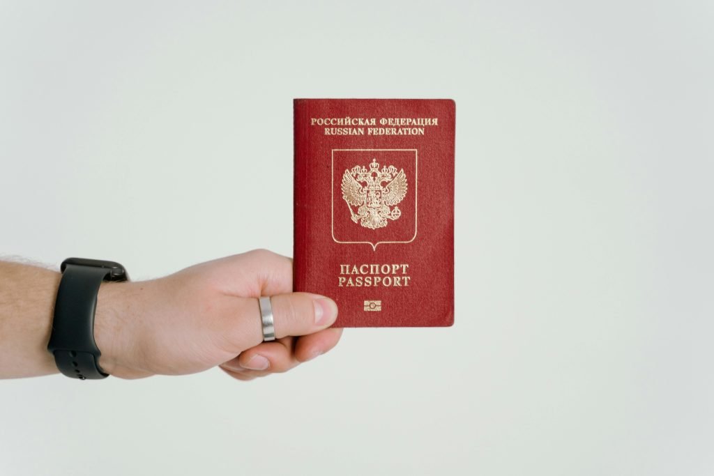 Close-up of a hand holding a Russian Federation passport., visados