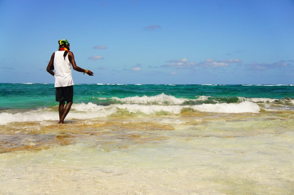 A lone fisherman casts his line in the clear blue waters at San Andrés, Colombia. Providencia