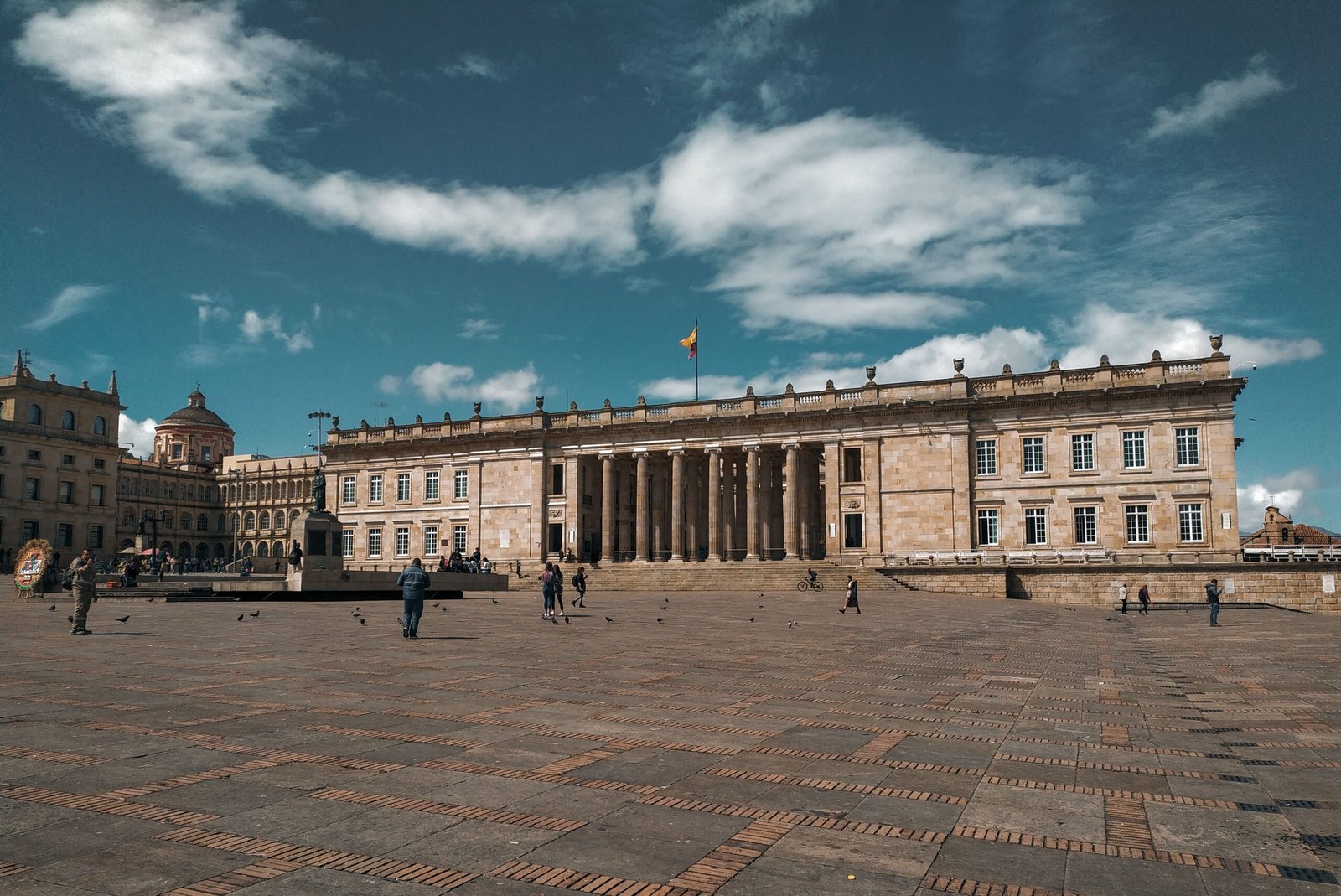 Glimpse the grand facade of Bolívar Square in Bogotá under a bright blue sky.