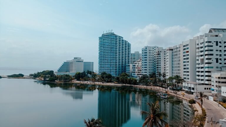 A scenic view of modern hotels reflecting in the water in Cartagena, Colombia.