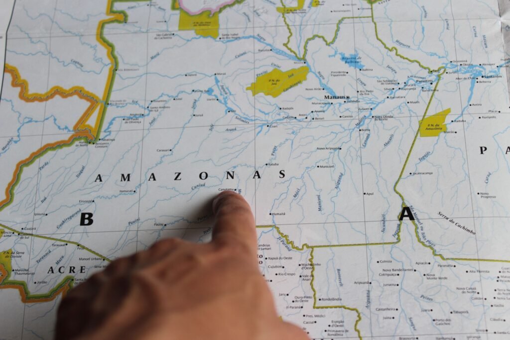 Photo of a hand pointing at Amazonas on a detailed map of Brazil. Amazonas
