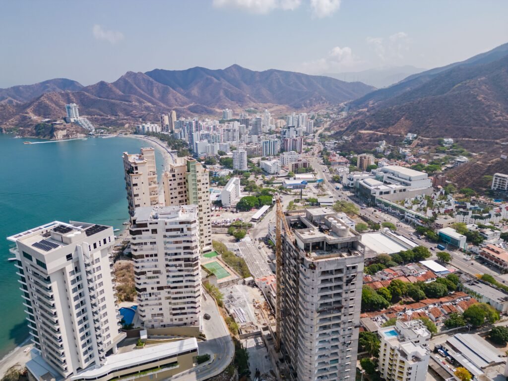 Drone shot of Santa Marta, Colombia showcasing urban skyline, coastline, and surrounding hills. Santa Marta