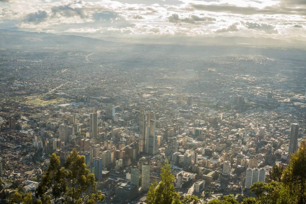 Stunning aerial view of Bogotá's urban landscape under a cloudy sky. Bogotá