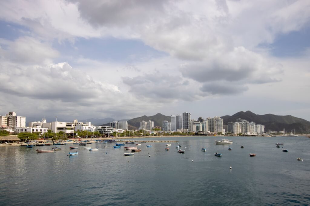 Skyline of Santa Marta, Colombia, with boats in the foreground and mountains in the background. Santa Marta