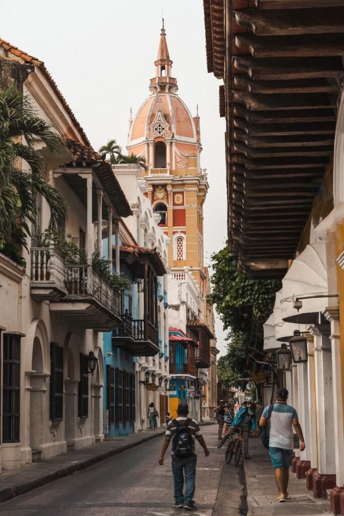Scenic street scene in Cartagena featuring the iconic cathedral tower., Vacaciones en Colombia
