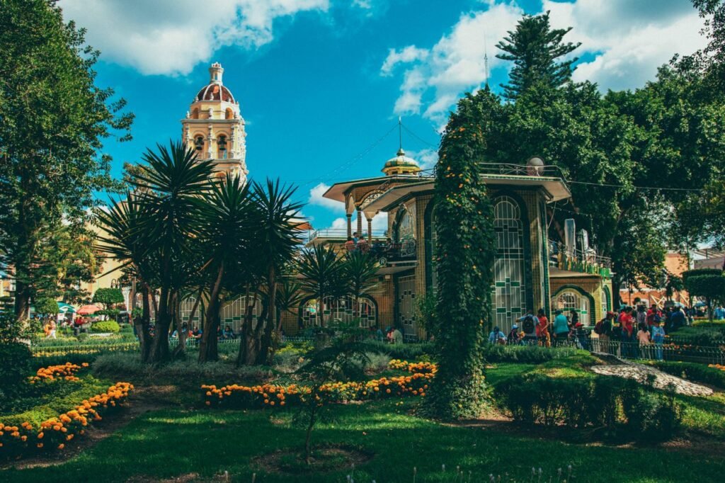 Scenic view of a vibrant garden and civic center in Atlixco, Mexico, captured on a sunny day. Feria de las flores