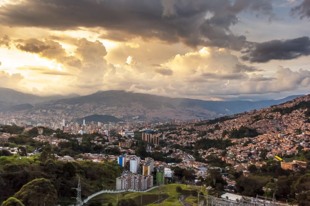 Breathtaking view of Medellin's skyline at sunset with dramatic clouds and vibrant colors. cuanto cuesta un viaje a colombia