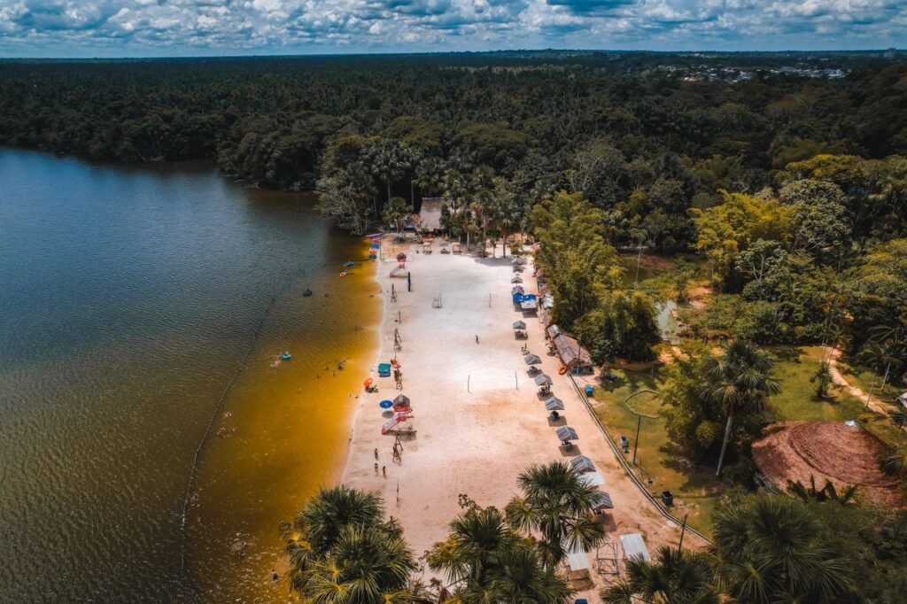Stunning aerial shot of a beach on Laguna Quistococha, surrounded by lush forest in Iquitos, Peru. dónde viajar