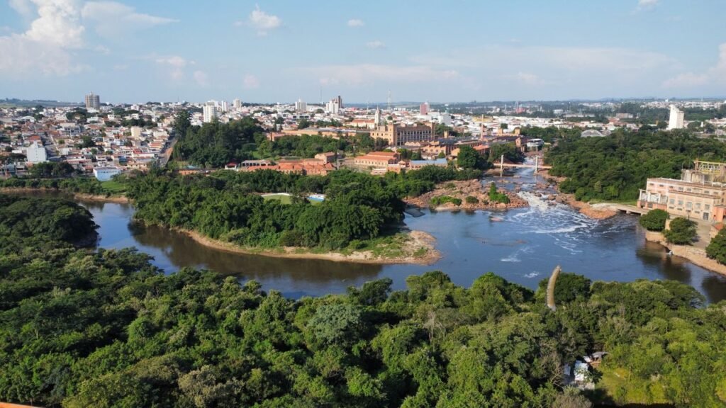 Stunning aerial view showcasing river, lush greenery, and a bustling cityscape., Guaviare