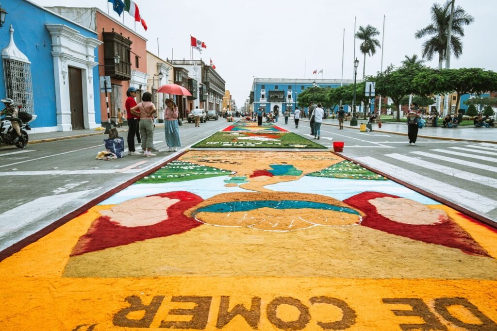 Colorful street art displayed during a cultural festival in Trujillo, Peru set against historic architecture. Feria de las flores